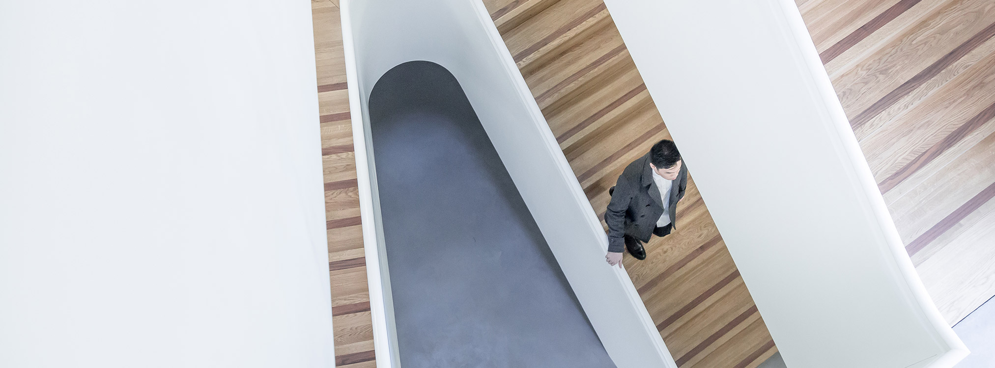 how we work - Man walking down modern stairs